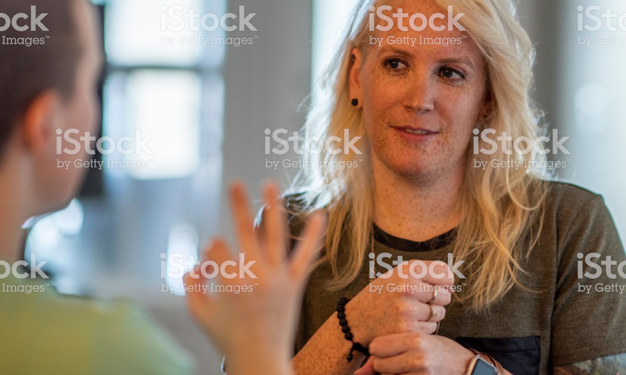 Deaf woman communicating with another woman